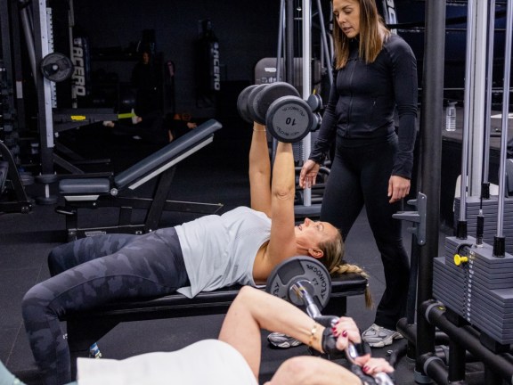 People lifting weights in a gym