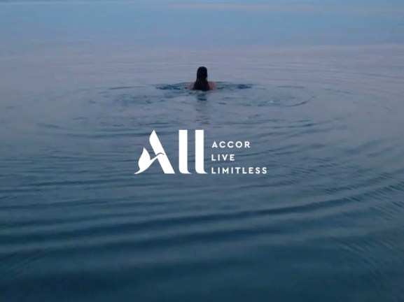 Accor Live Limitless branding with a person swimming.