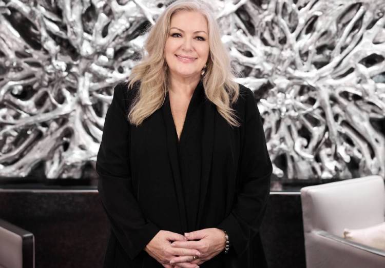Deb McDiarmid posing for a photo in front of a white background
